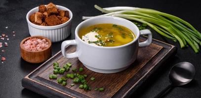 Fresh pea soup in bowl on black background. Cooking at home photo