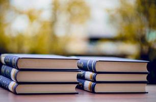 Many books are placed on the table, school supplies. Education concept photo