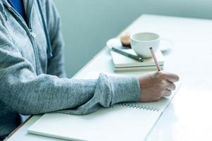 Writing on paper at work on the table in the morning, business ideas. There is space for copying. photo