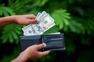 Dollar hand and purse images Concept of business finance photo