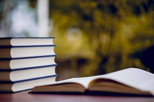 Many books are placed on the table, school supplies. Education concept photo