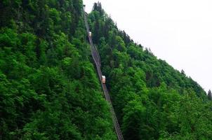 cable car on mountain with forest photo