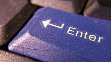 Close-up of the enter key on the keyboard for the attachment of an article about staff work. photo