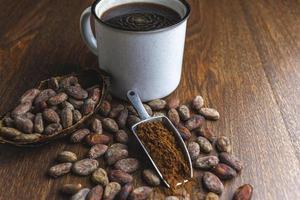 Hot cocoa drink or chocolate drink with cocoa powder and cocoa beans. photo