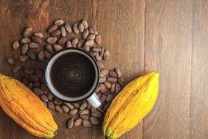 Hot cocoa drink or chocolate drink with cocoa powder and cocoa beans. photo