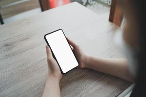 Asian woman hold mobile phone text or message. Businesswoman use modern smartphone to browse web, read e-book, trade stocks. photo