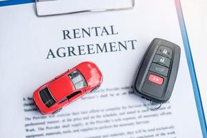 contract document with car and remote key. buy and sale, insurance, rental and contract agreement concepts photo