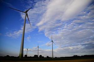 four windmills and beautiful sky photo