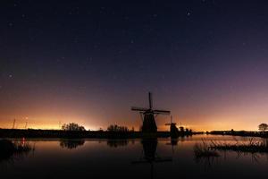 Starry sky over Dutch mills. photo