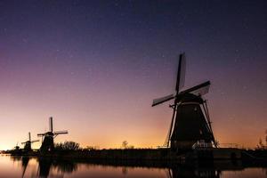 Starry sky over Dutch mills. photo