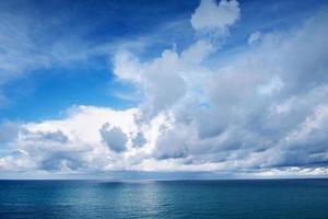 blue sea and white clouds in the sky photo