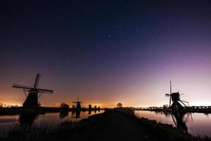 Starry sky over Dutch mills. photo