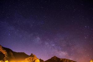 The starry sky above rocky dolomite photo