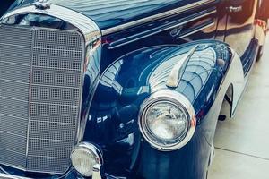 closeup of the headlights and front bumper on vintage automobile photo