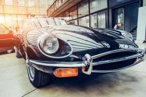 closeup of the headlights and front bumper on vintage automobile photo