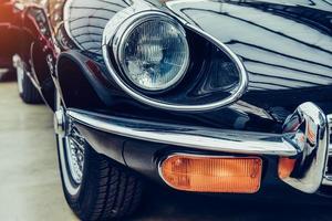 closeup of the headlights and front bumper on vintage automobile photo