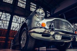 closeup of the headlights and front bumper on  vintage automobile photo