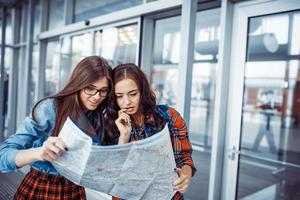 Two girlfriends looking for a route map.Art processing and retou photo