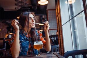 Beer woman enjoying a fresh draft  on cafe. Art processing photo