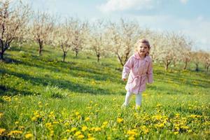 child outdoors in the blossom trees. Art processing and retouchi photo