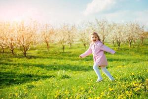 child running outdoors blossom trees. Art processing and retouch photo