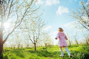 child running outdoors blossom trees. Art processing and retouch photo
