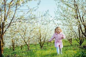 child running outdoors blossom trees. Art processing and retouch photo