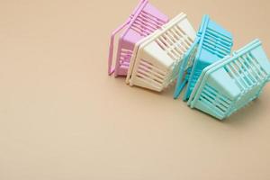 Colored empty shopping baskets on a beige background. Minimalism. Sales, shopping, prices concept photo