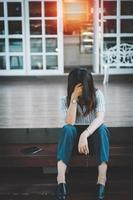 Business woman stressed from work while sitting outdoors on the stairs, concept work life balance, burn out syndrome, Depression concept. photo