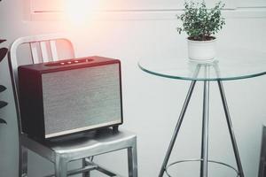 Modern radio sits on a white table in the kitchen. Radio receiver. The music column of the device. Stylish music radio channel receiver. photo