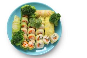 Vegetable Roll, Minced Pork, Crab Stick, Chicken with Broccoli in Blue Plate isolated on white background with clipping path. Salad rolls. Top view of healthy food. photo