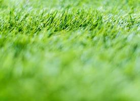 Texture of plastic artificial grass of school yard by shallow depth of field photo