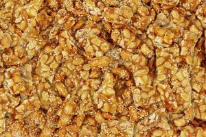 Nut Bars texture for background. Peanut Bar snack are made from mixing and compressing peanuts, white sesame seeds and sugar. photo