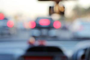 Abstract blurred of brake light of the car while the traffic jam on the road. View from inside car. photo