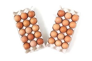 Eggs of chicken in paper tray on white background. Top view. photo