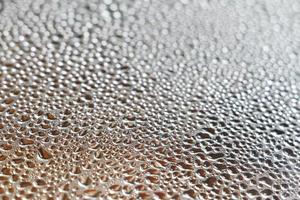 Selective focus of water droplets on the window glass. Abstract background of blurred raindrops. photo