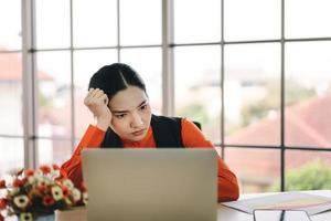 Young adult business woman work in office has burnout syndrome photo