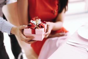 Couple man and woman with romantic present gift box. photo