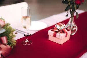 Valentine date dinner table with gift box photo