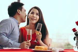 Adult asian lover couple man and woman dating dinner at restaurant on festive day. photo