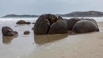 Moeraki Boulders at Koekohe Beach on the wave-cut Otago coast of New Zealand photo