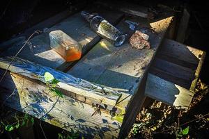 Bottles on a bench in a derelict building photo