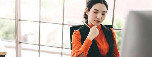 Young adult asian employee business woman in indoor office on day photo