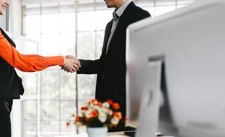 Asian adult business man and woman partner handshake together. photo