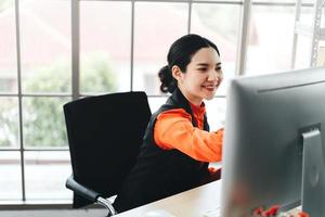 Business asian woman work with happy smile and concentration to job photo