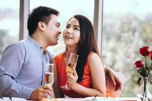 Young adult couple talking while dinner time at restaurant on dating day photo