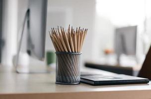 Minimal office workplace modern style. Wooden desk with pencil. photo