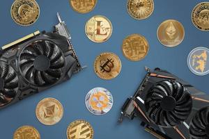 Crypto coins and graphic cards on desk. Concept of crypto mining. Top view, flat lay
