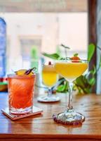 pisco sour cocktail on the table in bar, italian pear and colorful cocktails standing on the table in the bar photo