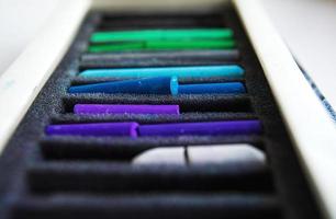 Pieces of colorful pastel chalks in the box photo